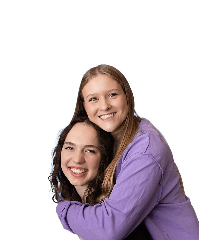 Two Girl smiling and hugging