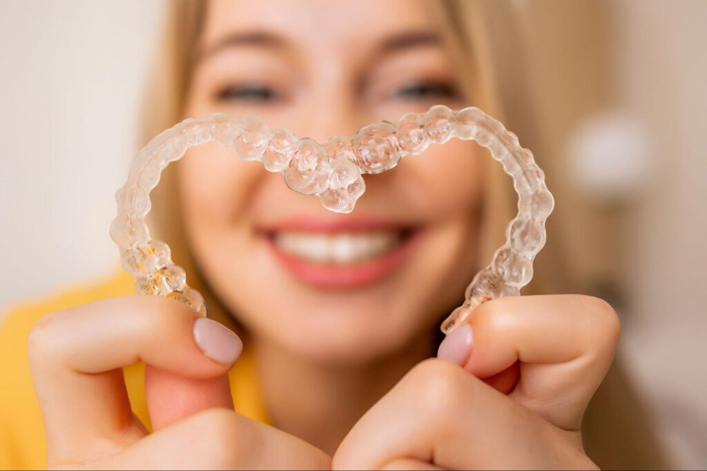 Happy patient showing off their straight smile after Franklin Invisalign treatment at Stewart Smiles